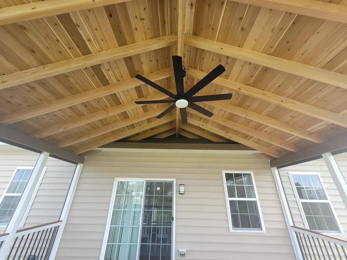 Vaulted cedar tongue-and-groove porch ceiling with ceiling fan