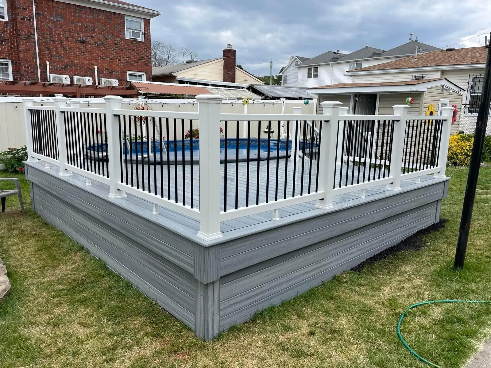 White vinyl pool fence with composite decking installed by Prodecks contractor