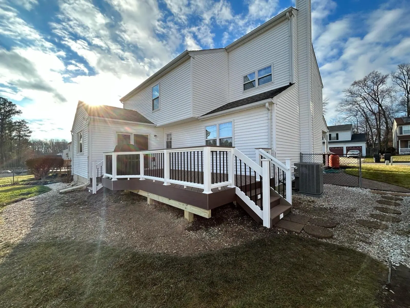 Composite deck with white railings at sunset in New Castle County Delaware