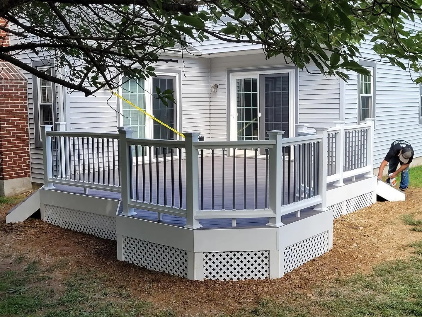 Custom composite deck with white vinyl railings and lattice skirting